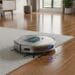 Smart AI robot vacuum moving across carpet in bright living space