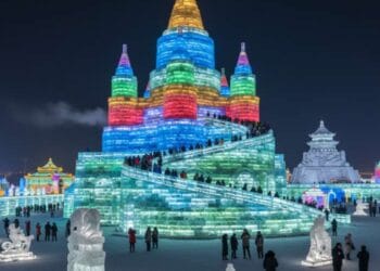 Colorful ice castles and sculptures illuminated with bright lights at the Harbin International Ice and Snow Festival in China