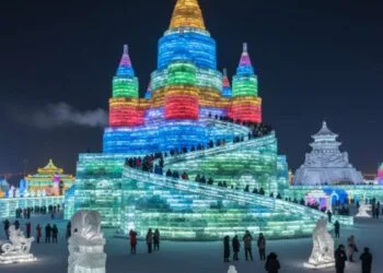 Colorful ice castles and sculptures illuminated with bright lights at the Harbin International Ice and Snow Festival in China