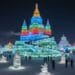 Colorful ice castles and sculptures illuminated with bright lights at the Harbin International Ice and Snow Festival in China